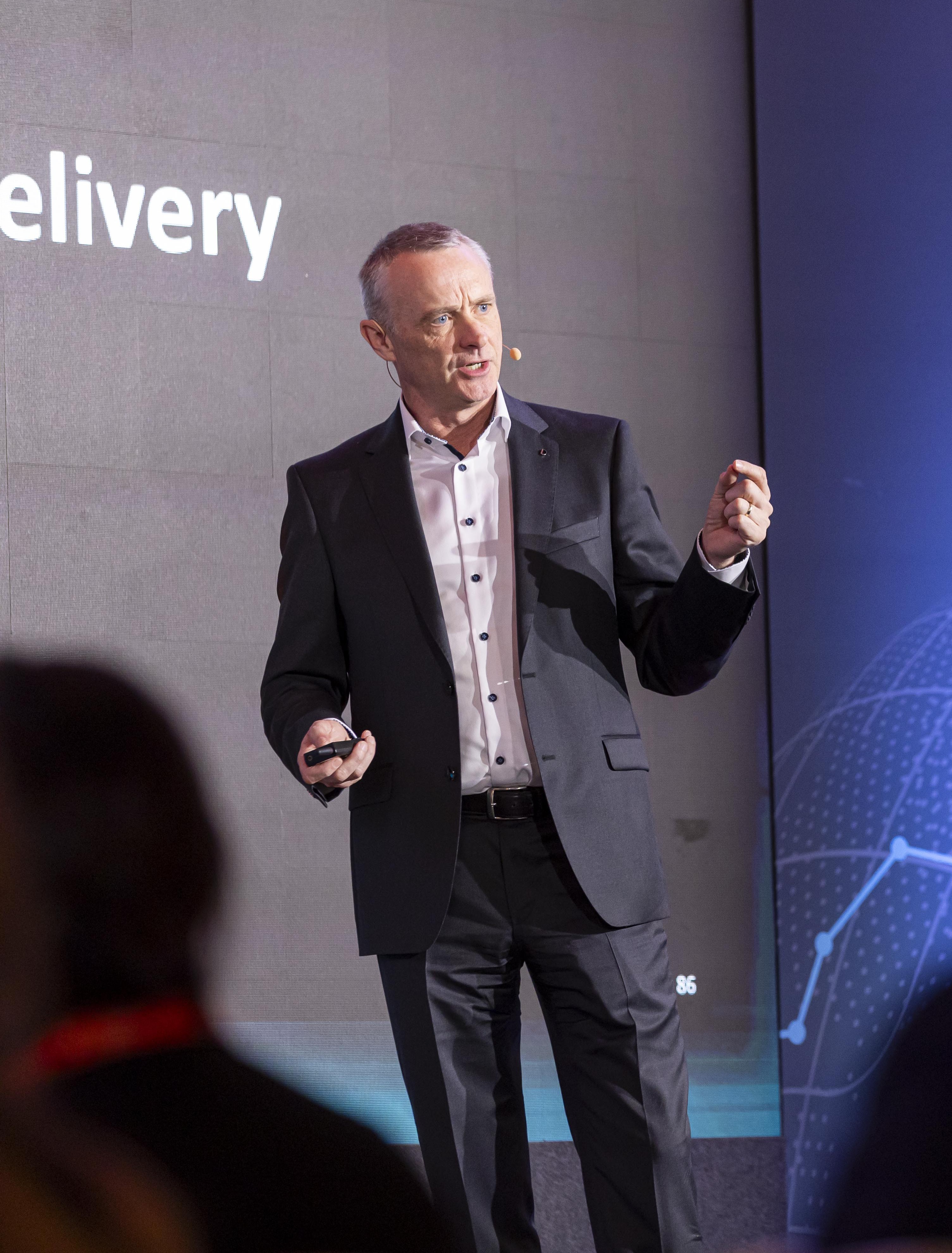 Garrett O'Keeffe delivering a keynote presentation on stage